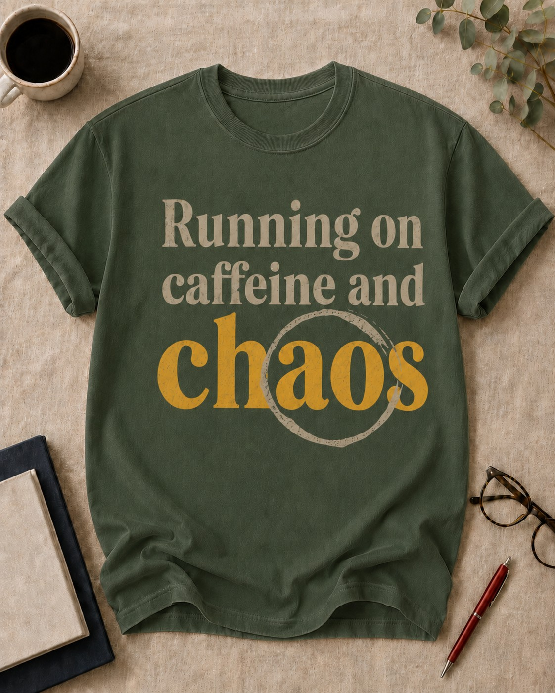 Running on caffeine and chaos — teacher t-shirt in Moss, flat lay