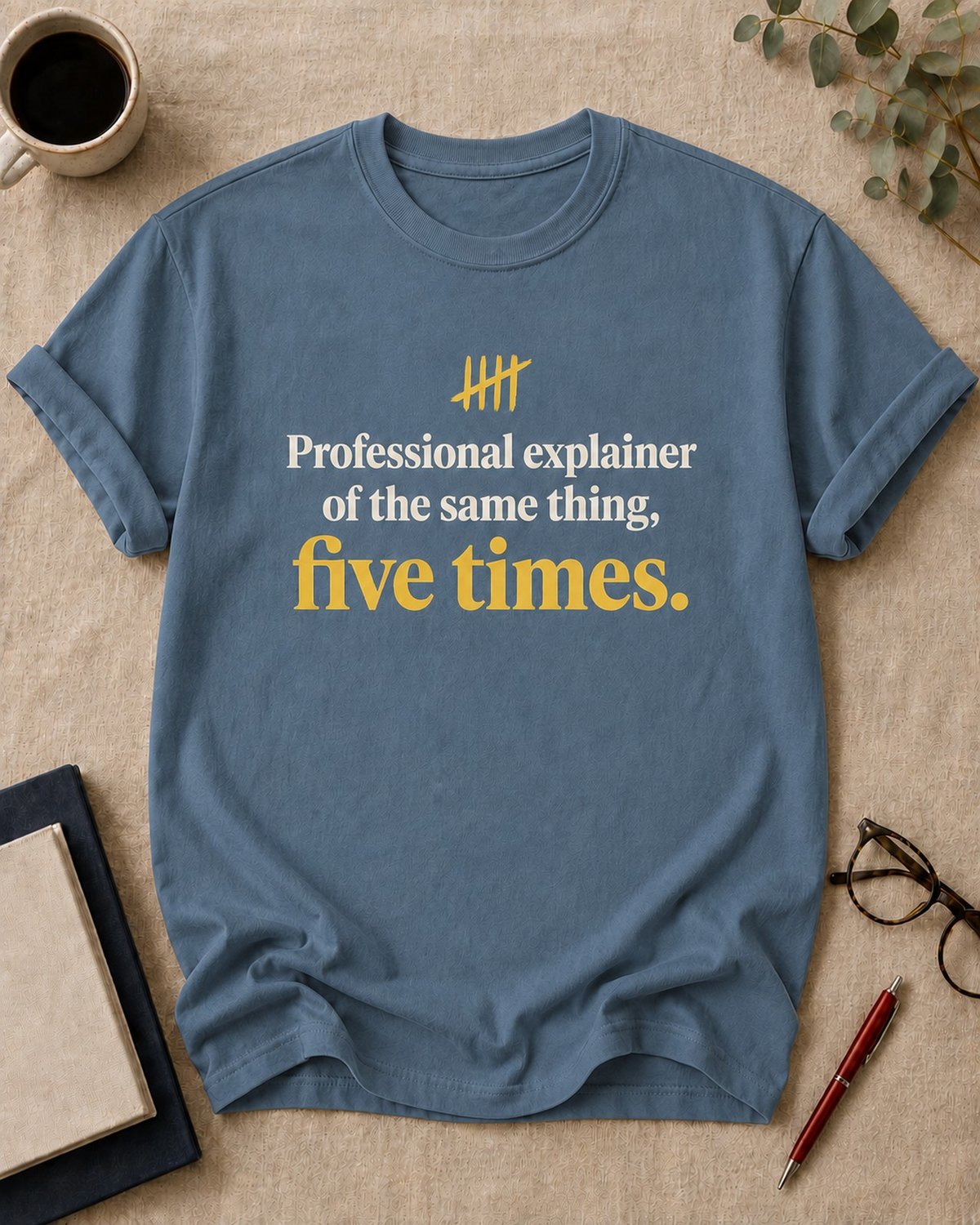 Professional explainer of the same thing, five times — teacher t-shirt in Blue Jean, flat lay