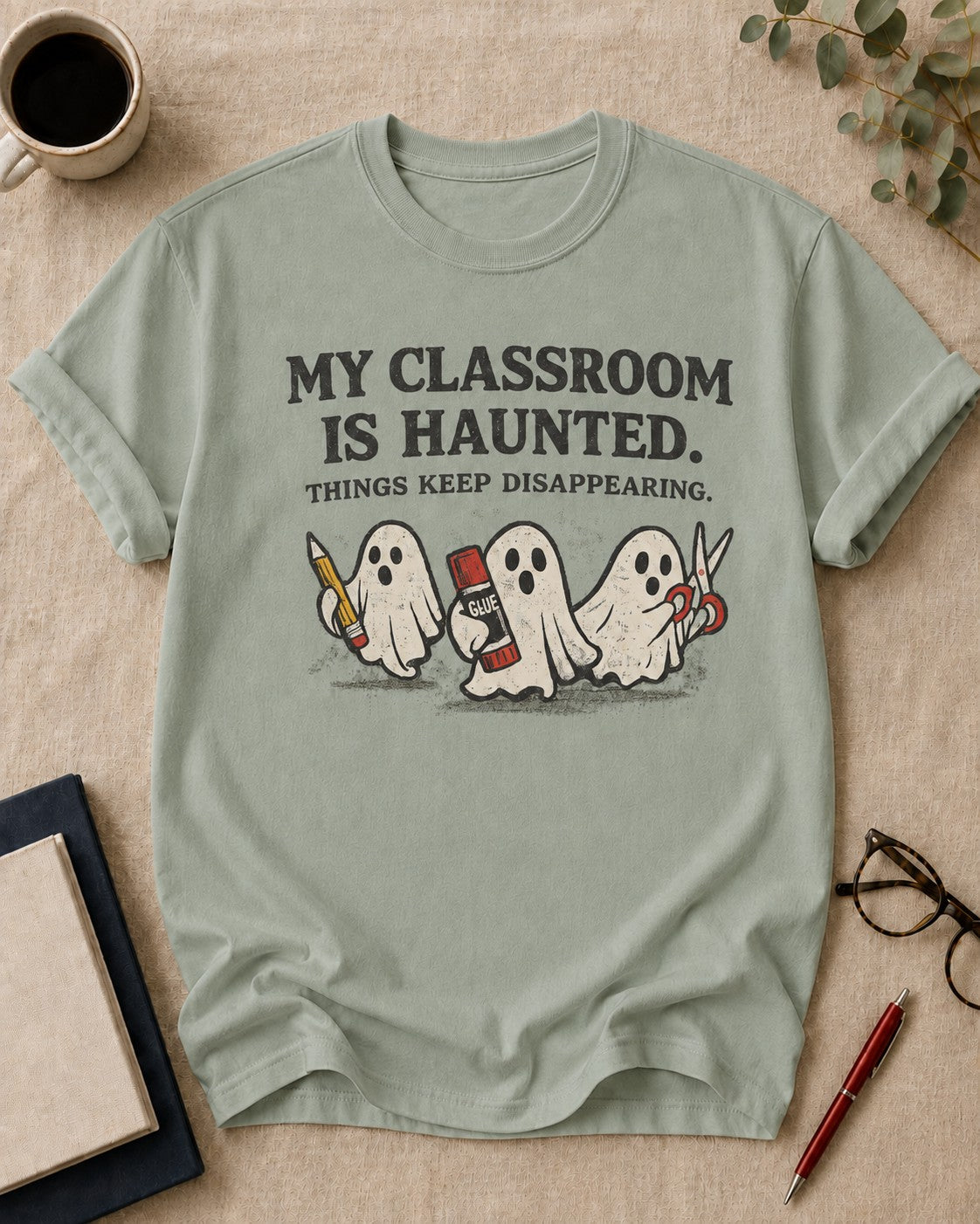 My classroom is haunted — teacher t-shirt in Bay, flat lay