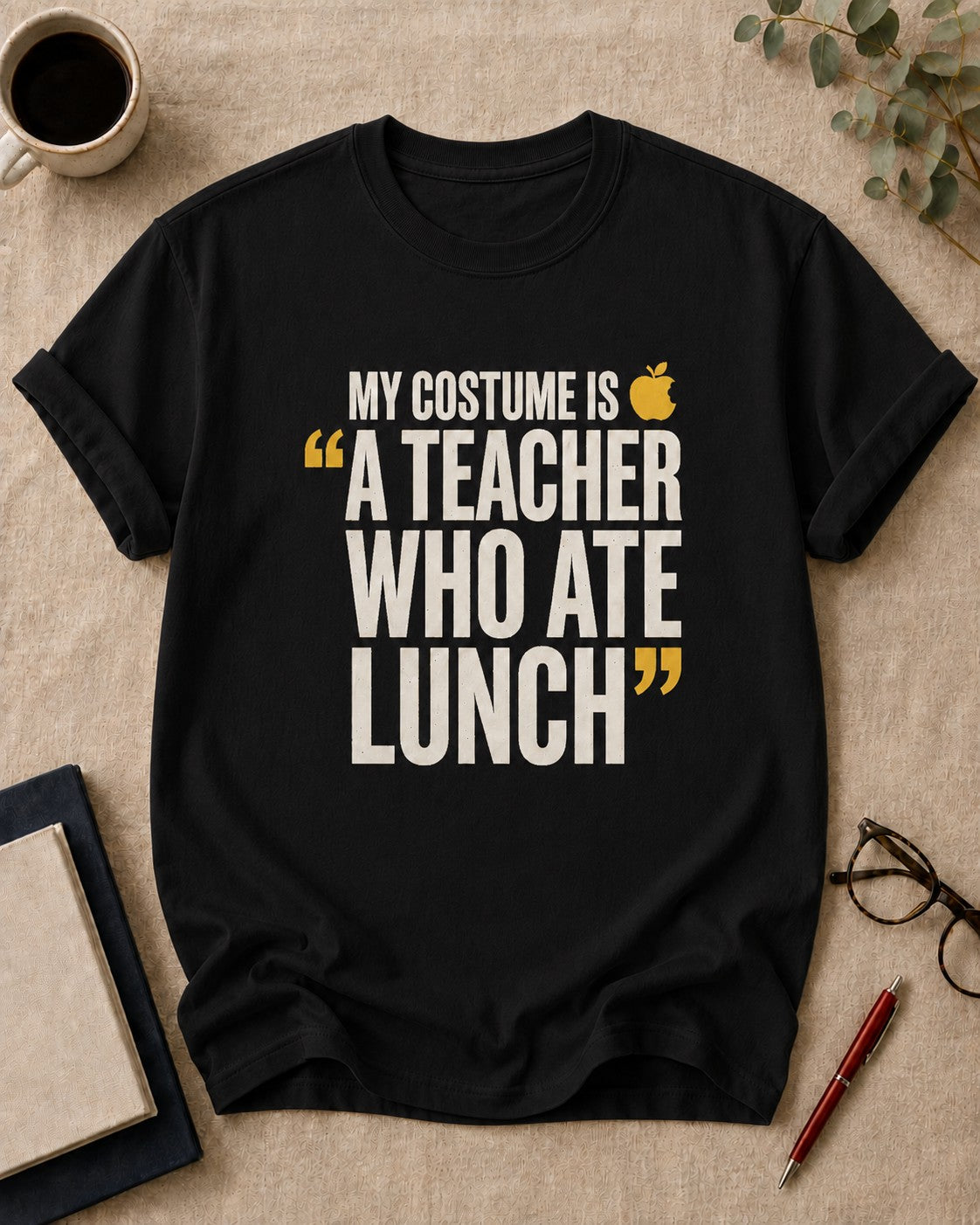 My costume is "a teacher who ate lunch." — funny t-shirt in Black, flat lay