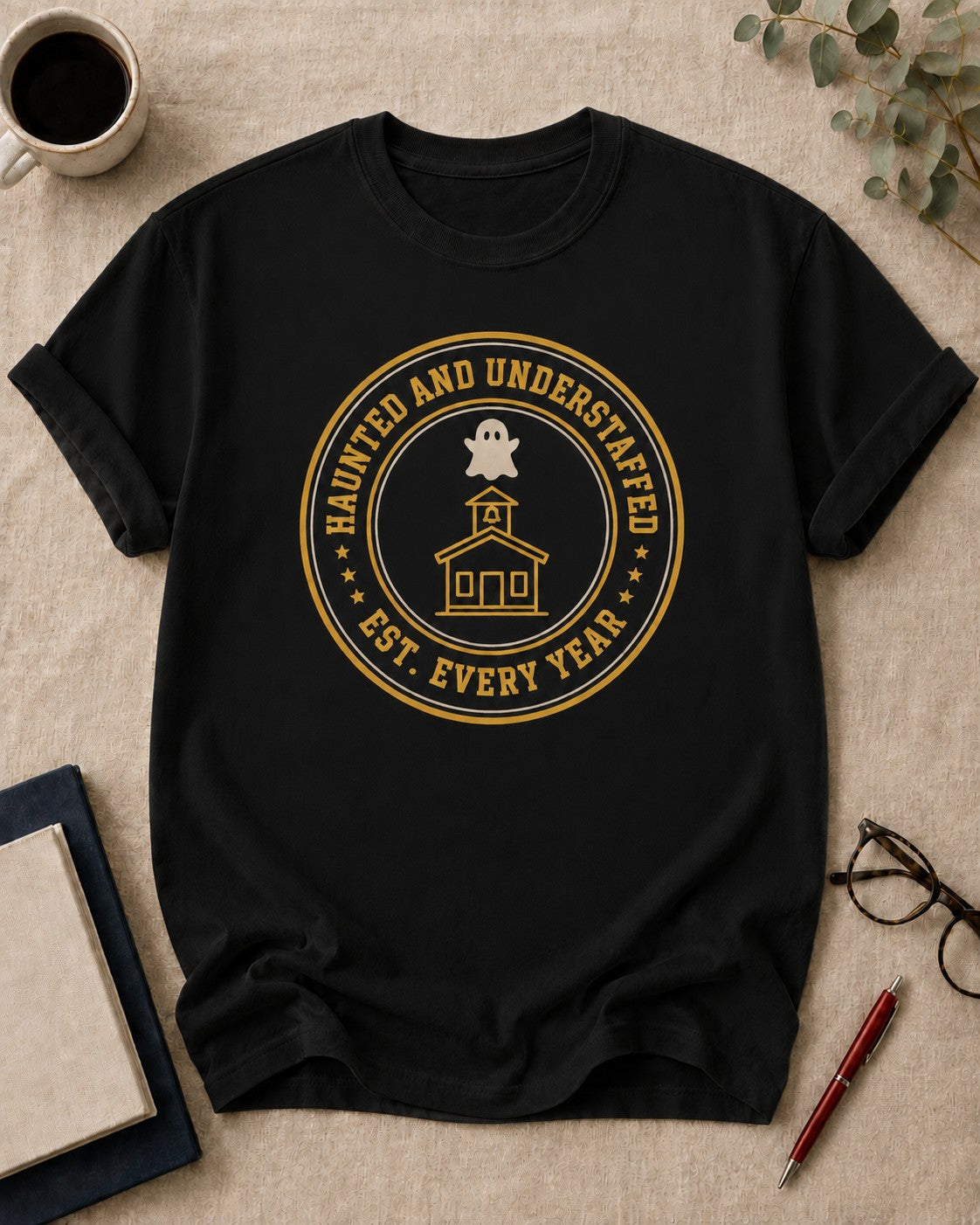 Haunted and understaffed — teacher t-shirt in Black, flat lay