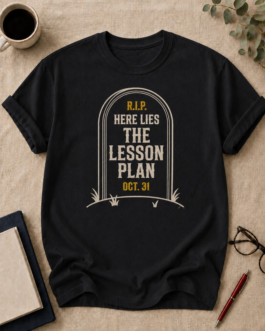 Here Lies the Lesson Plan — teacher t-shirt in Black, flat lay