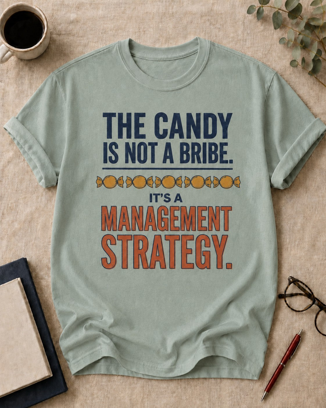 The candy is not a bribe. It's a management strategy — teacher t-shirt in Bay, flat lay