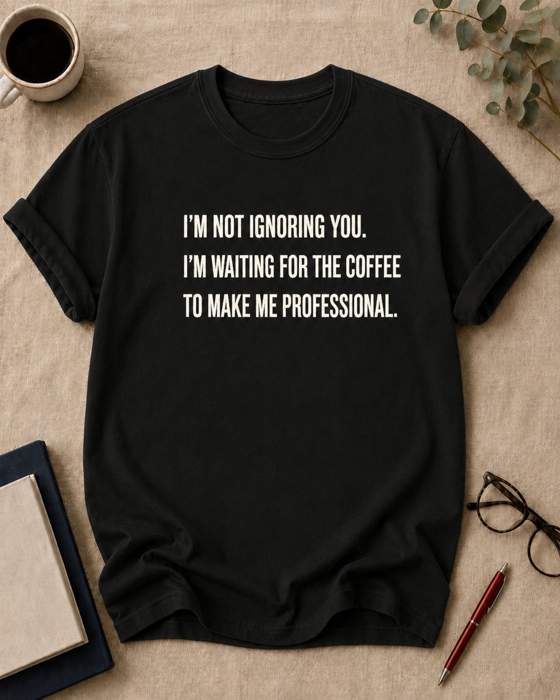 I'm not ignoring you. I'm waiting for the coffee to make me professional. teacher t-shirt in Black, flat lay