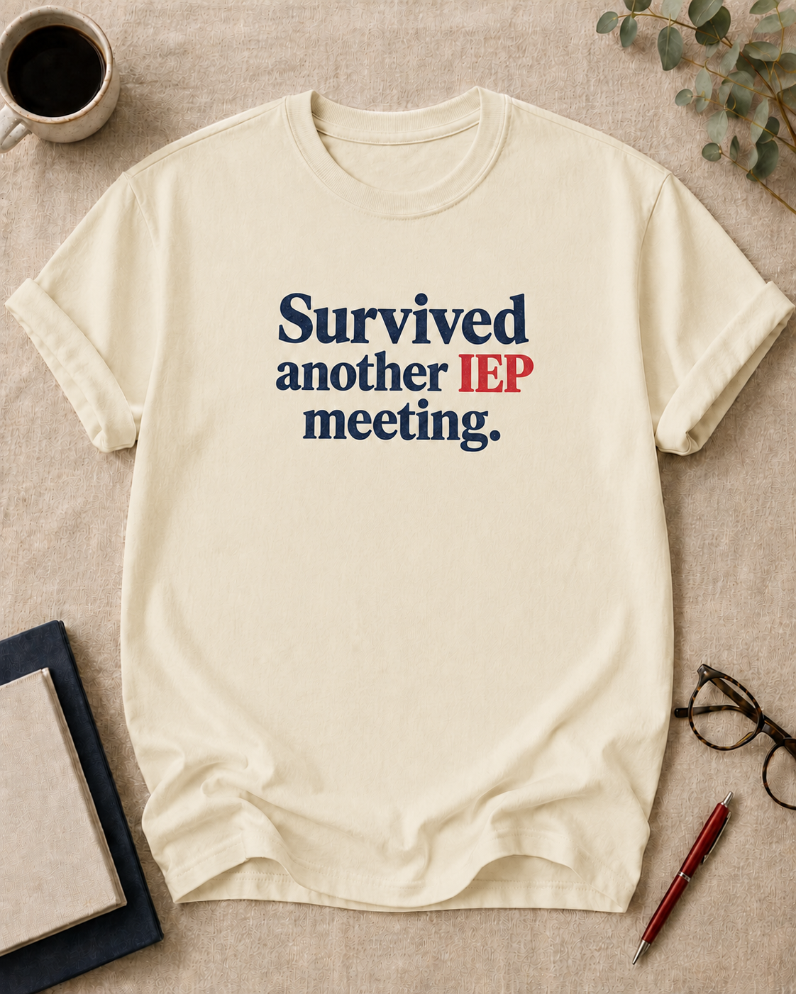 Survived another IEP meeting — teacher t-shirt in Ivory, flat lay