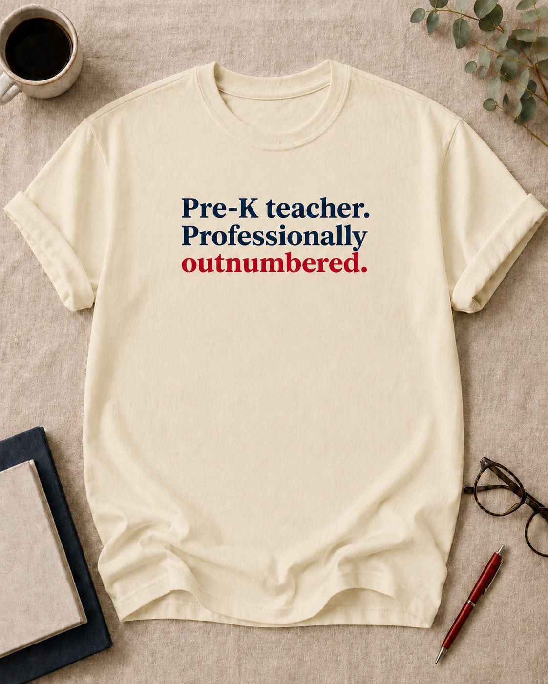 Pre-K teacher. Professionally outnumbered — funny t-shirt in Ivory, flat lay